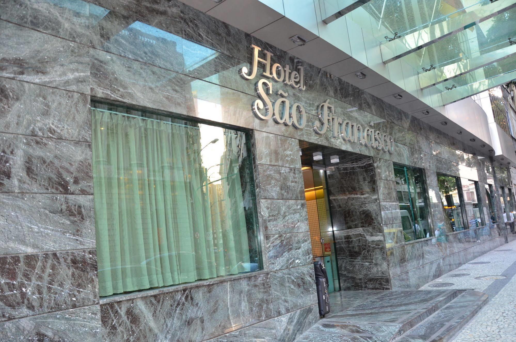 Hotel Atlantico Tower Рио-де-Жанейро Экстерьер фото The photo shows the exterior of a hotel named "Hotel São Francisco." The facade is made of marble, giving it an elegant appearance, and large glass windows are visible, likely allowing natural light to enter the interior. There are light green curtai